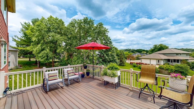 wooden deck featuring a yard