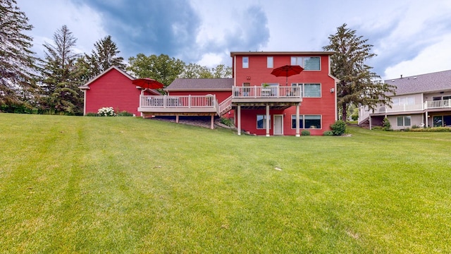 back of house featuring a lawn and a wooden deck