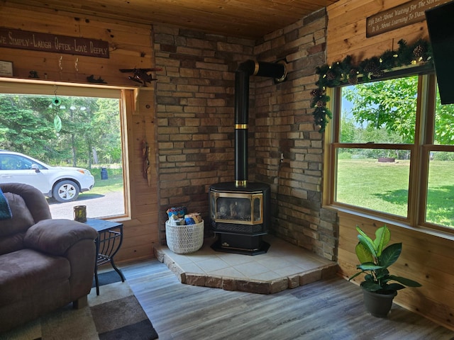 2228 Town Rd Unit 461, International Falls, MN 56649 - living room with a wood stove, wood finished floors, wooden walls, and wood ceiling