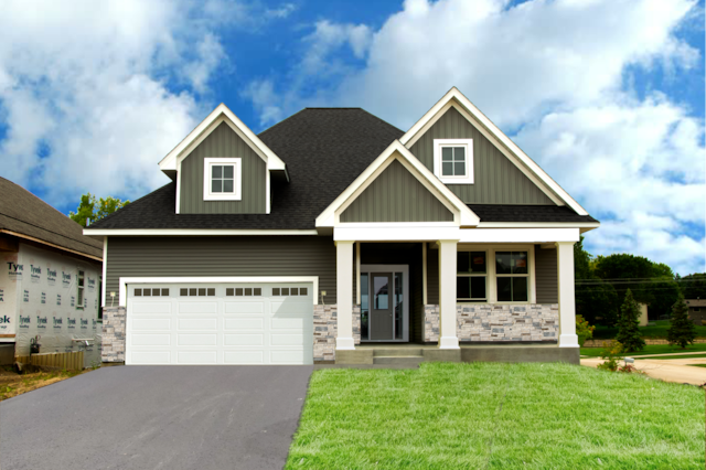 craftsman house with a front yard, covered porch, and a garage