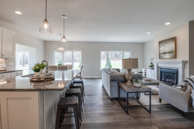 living room with dark wood-type flooring and an inviting chandelier