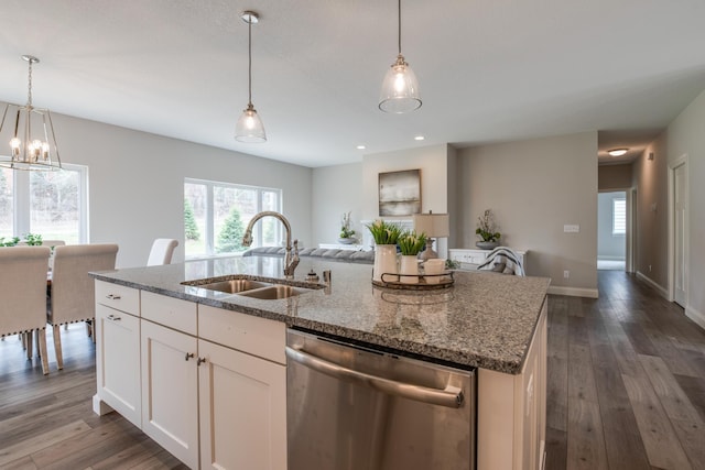 kitchen with white cabinetry, an island with sink, light stone countertops, stainless steel dishwasher, and sink