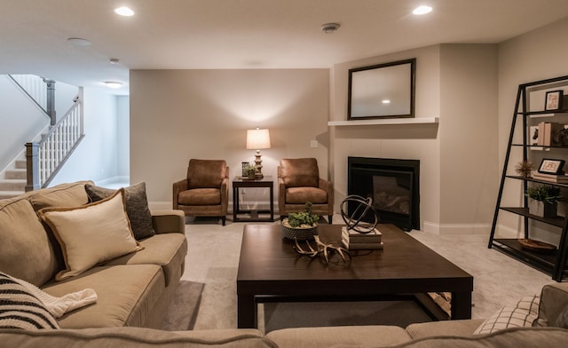 carpeted living room featuring a fireplace