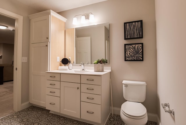 bathroom featuring tile patterned floors, toilet, and vanity