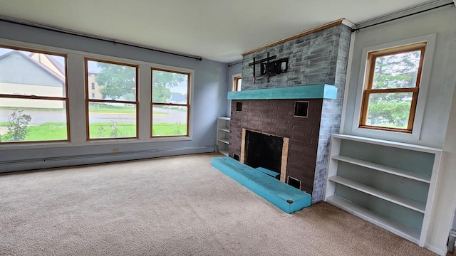 unfurnished living room featuring baseboard heating, a fireplace, and carpet