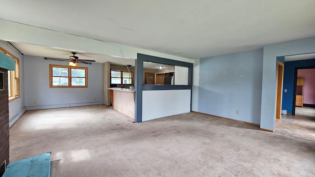 empty room with a baseboard heating unit, carpet flooring, and ceiling fan