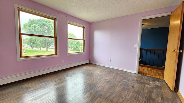 spare room featuring a textured ceiling, a baseboard radiator, and dark hardwood / wood-style floors