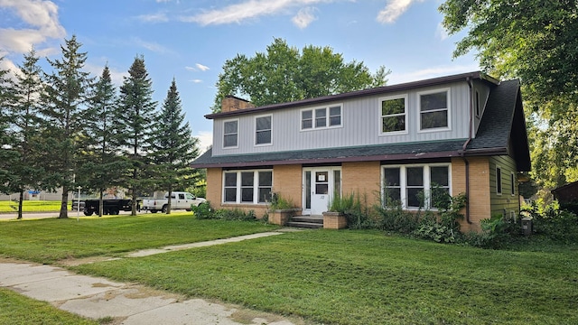 view of property featuring a front lawn