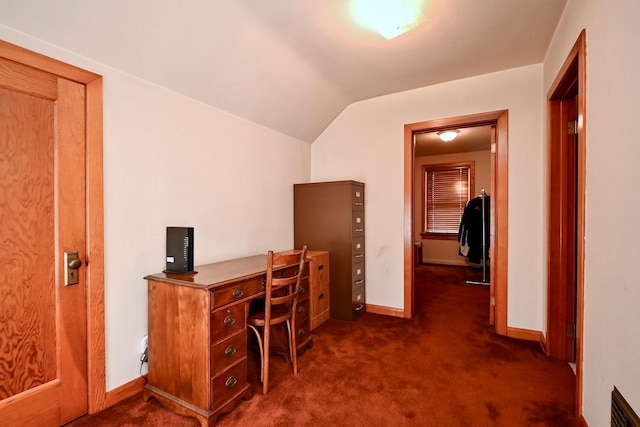 office with lofted ceiling, baseboards, visible vents, and dark carpet