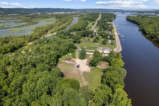 drone / aerial view featuring a forest view and a water view