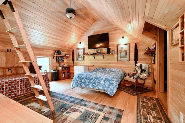 bedroom featuring vaulted ceiling, wooden walls, wood finished floors, and wooden ceiling