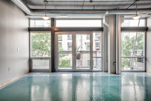 empty room with expansive windows and a towering ceiling