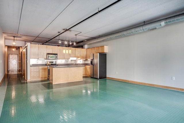 kitchen featuring hanging light fixtures, light brown cabinets, a center island, and stainless steel appliances