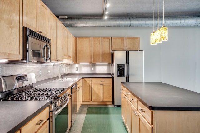 kitchen featuring light brown cabinetry, sink, and appliances with stainless steel finishes