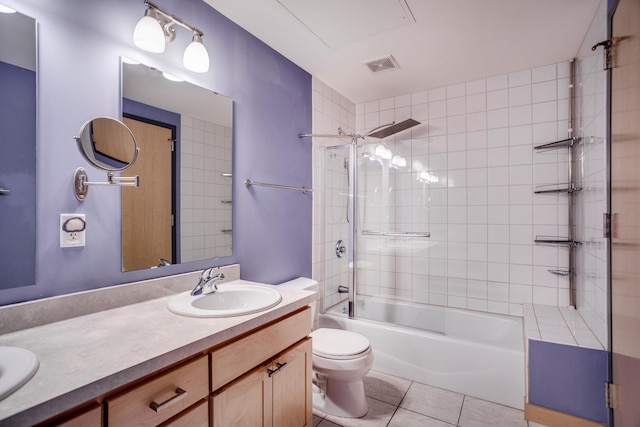 full bathroom with tile patterned flooring, vanity, toilet, and tiled shower / bath