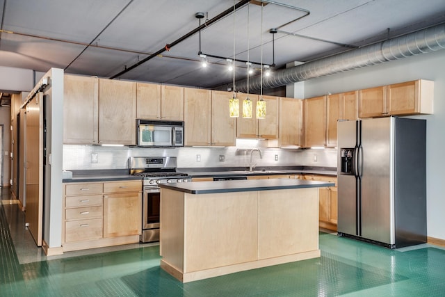 kitchen featuring dark countertops, pendant lighting, stainless steel appliances, and light brown cabinetry