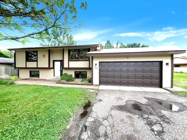 view of front facade featuring a front yard and a garage