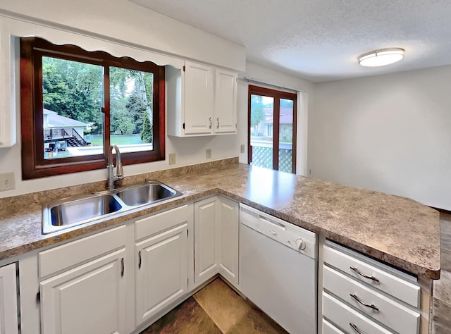 kitchen featuring dishwasher, white cabinets, kitchen peninsula, and sink