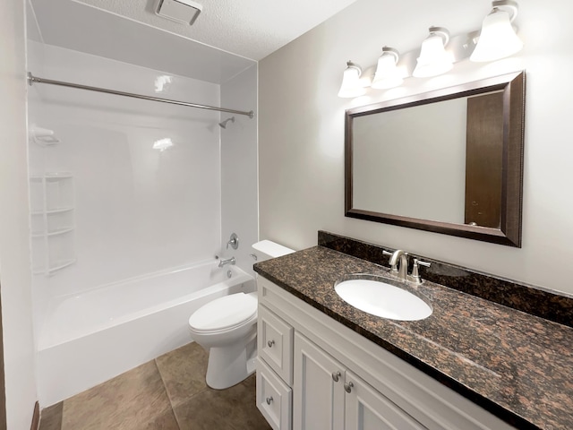 full bathroom featuring vanity, a textured ceiling, shower / tub combination, tile patterned flooring, and toilet