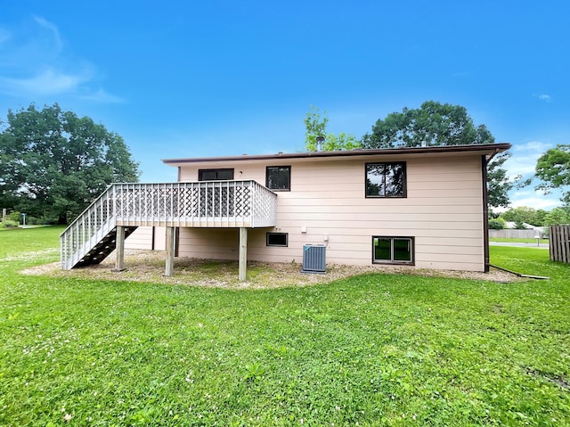 back of property with central AC unit, a yard, and a wooden deck