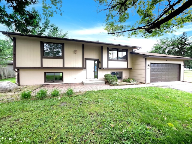 raised ranch with a garage and a front yard