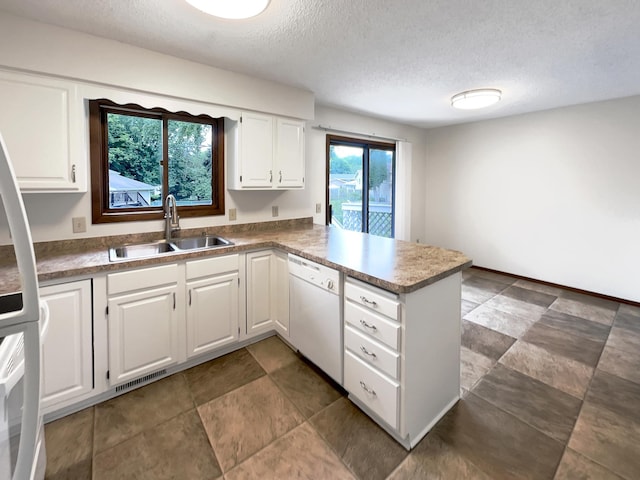 kitchen with white cabinets, a textured ceiling, and white dishwasher