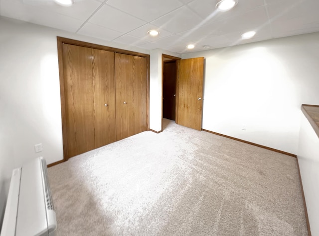 unfurnished bedroom with light colored carpet and a closet