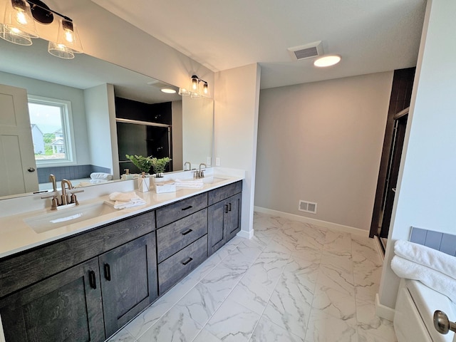 bathroom featuring marble finish floor, a sink, and visible vents