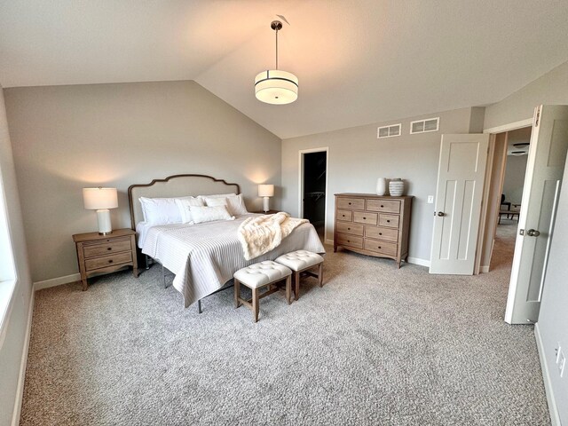 carpeted bedroom featuring baseboards, visible vents, and vaulted ceiling