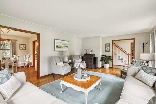 9642 Upton Rd, Minneapolis, MN 55431 - living room with wood finished floors, a chandelier, stairway, and baseboards