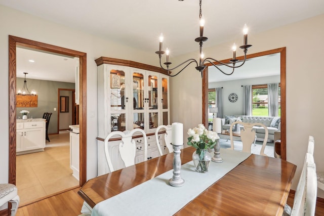 9642 Upton Rd, Minneapolis, MN 55431 - dining room with a chandelier and light wood-style flooring