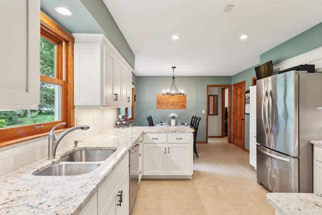 9642 Upton Rd, Minneapolis, MN 55431 - kitchen featuring stainless steel appliances, a sink, a chandelier, white cabinets, and recessed lighting