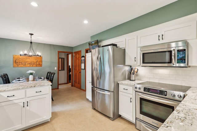 9642 Upton Rd, Minneapolis, MN 55431 - kitchen with appliances with stainless steel finishes, backsplash, white cabinetry, recessed lighting, and decorative light fixtures