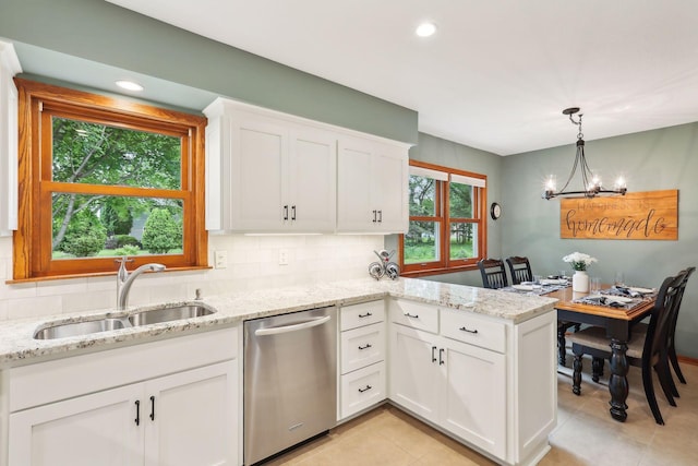 9642 Upton Rd, Minneapolis, MN 55431 - kitchen with stainless steel dishwasher, a sink, a chandelier, a peninsula, and white cabinets