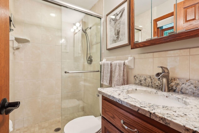 9642 Upton Rd, Minneapolis, MN 55431 - full bath featuring vanity, a stall shower, toilet, and tasteful backsplash