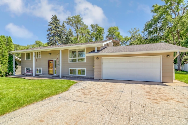 bi-level home with a front lawn and a garage