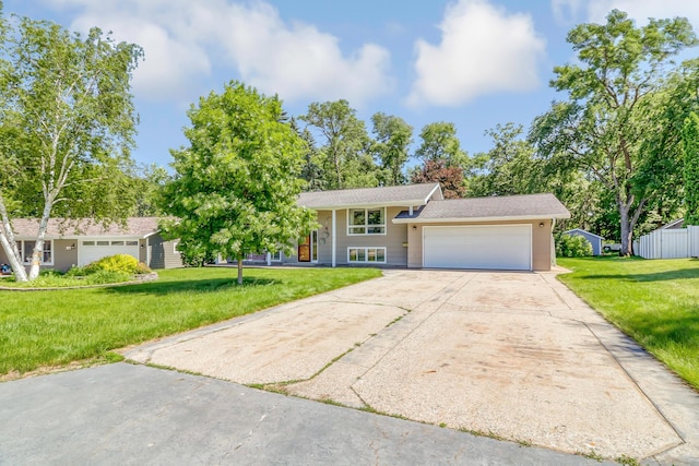 view of front of property with a garage and a front yard