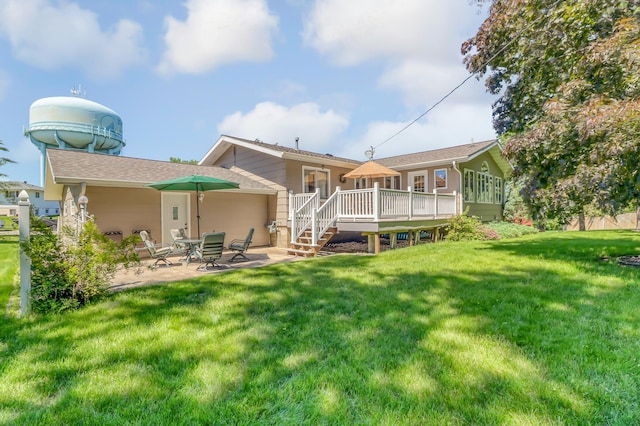 back of house featuring a deck, a yard, and a patio