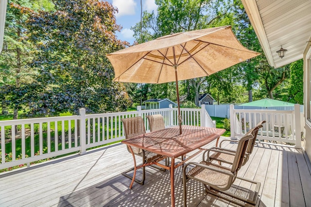 wooden deck featuring a storage unit