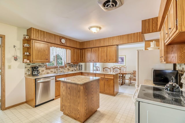 kitchen featuring dishwasher, a center island, stove, sink, and tasteful backsplash