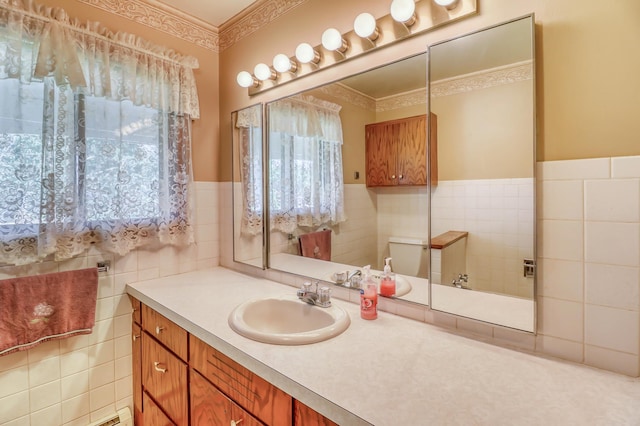 bathroom with vanity, tile walls, and toilet