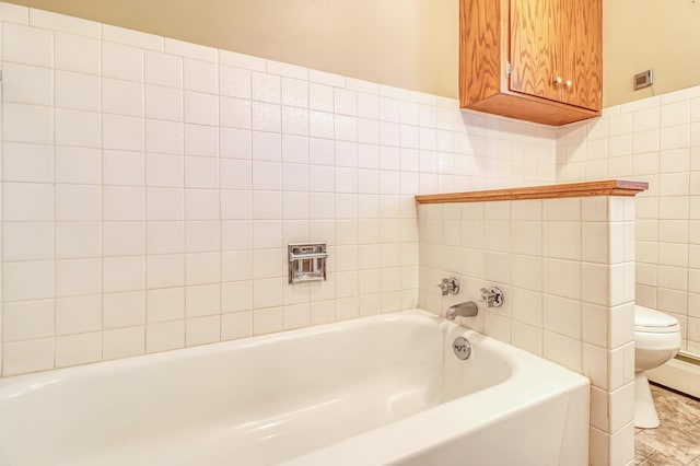 bathroom with a bathing tub, tile walls, and toilet