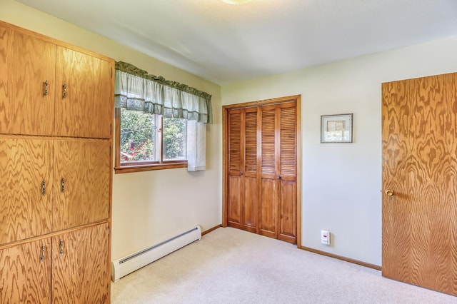 unfurnished bedroom featuring a closet, light carpet, and a baseboard radiator