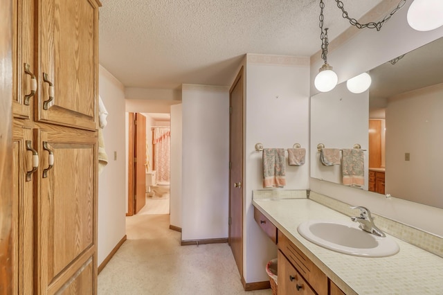 bathroom with vanity and a textured ceiling