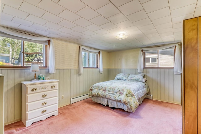 bedroom featuring light carpet and baseboard heating