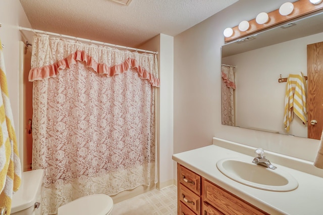 full bathroom featuring shower / tub combo with curtain, vanity, a textured ceiling, and toilet