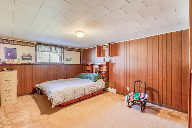 bedroom with a baseboard radiator, light colored carpet, and wood walls