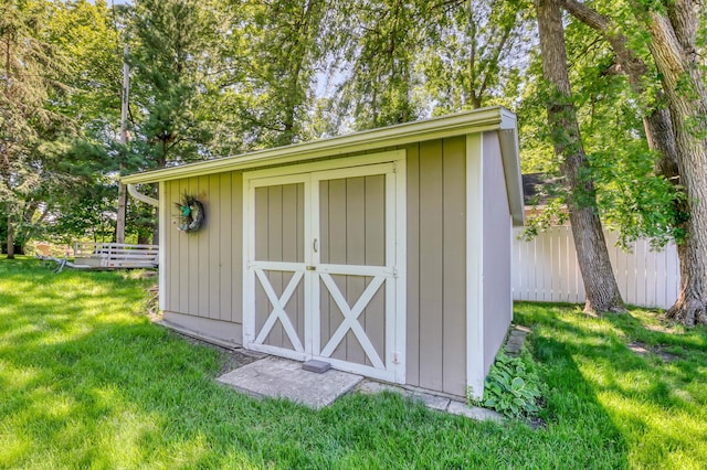 view of outbuilding with a lawn