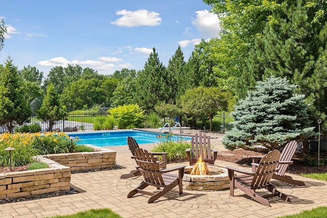 view of pool featuring a fire pit and a patio