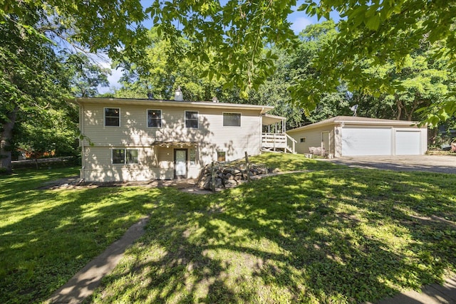 view of front of property featuring a garage, an outdoor structure, and a front yard